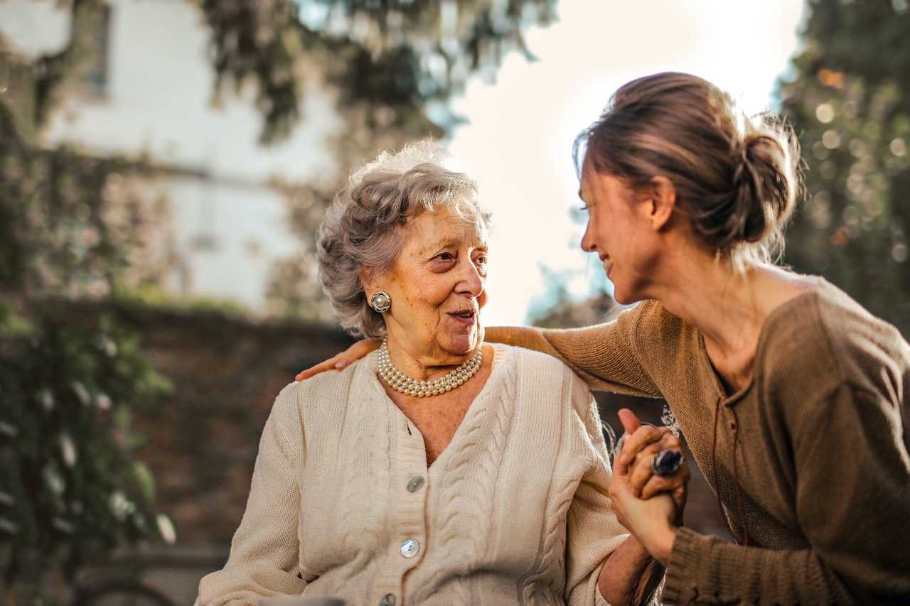 A young person embracing her mother